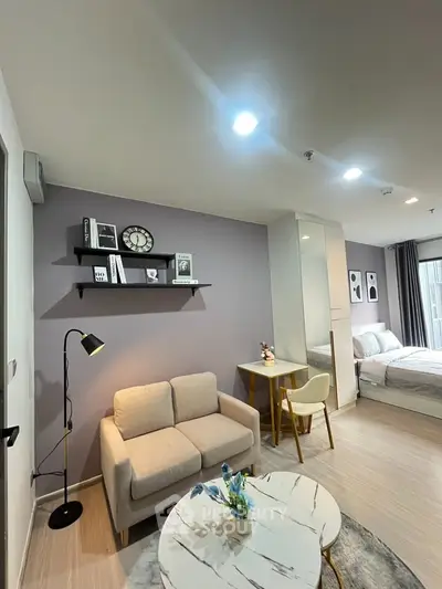 Modern studio apartment with cozy living area and stylish decor