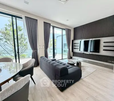 Modern living room with sleek design and large windows offering natural light.