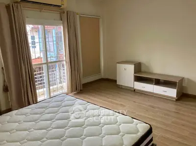 Spacious bedroom with balcony access and modern furnishings.