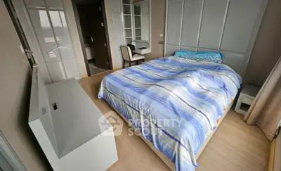 Cozy bedroom with modern furnishings and ample natural light