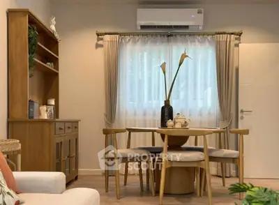 Cozy dining area with wooden furniture and elegant decor in a modern apartment.
