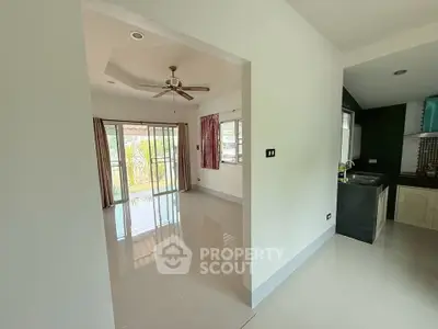 Spacious open-plan living area with modern kitchen and large windows