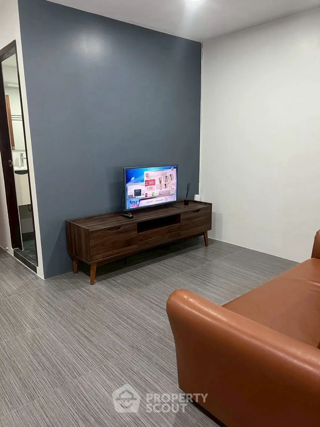 Modern living room with sleek TV stand and leather sofa