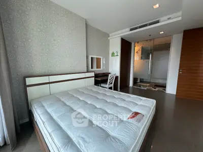 Spacious modern bedroom with stylish decor and large windows
