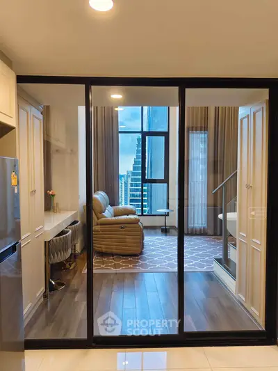 Modern living room with glass partition and city view, featuring stylish furniture and elegant decor.