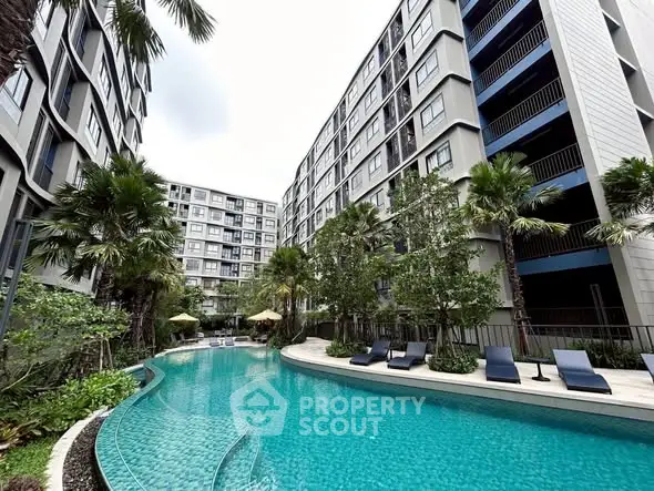 Luxurious apartment complex with stunning pool and lush greenery