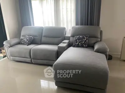 Modern living room with plush gray sectional sofa and elegant decor