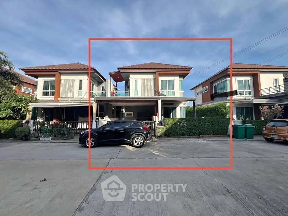 Modern two-story house with car parked in front, showcasing contemporary architecture and spacious driveway.