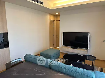 Modern living room with sleek TV setup and stylish furniture in a contemporary apartment.