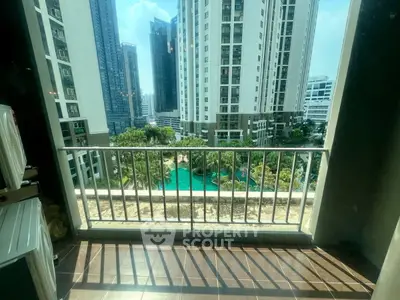 Stunning balcony view overlooking a luxurious pool and modern high-rise buildings.