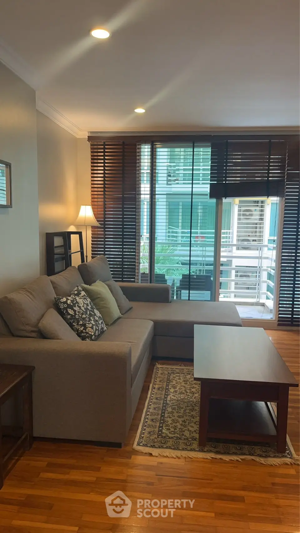 Cozy living room with modern sofa and wooden flooring, perfect for relaxation.