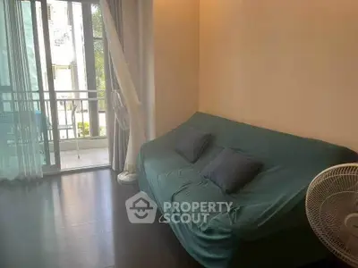 Cozy living room with balcony access and natural light