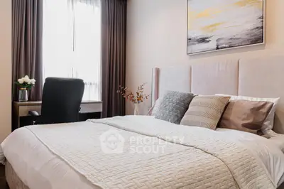 Elegant bedroom with plush bedding, tasteful artwork, and a cozy work nook, perfect for modern living and comfort.