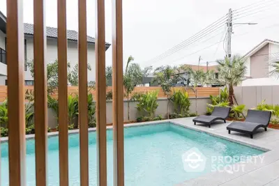 Luxurious outdoor pool area with modern design and lush greenery