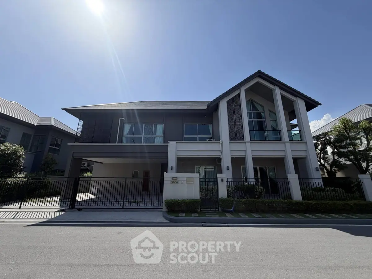 Stunning modern two-story house with sleek architecture and spacious driveway in a serene neighborhood.