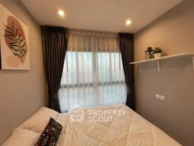 Cozy bedroom with elegant decor and large window, featuring modern lighting and stylish curtains.