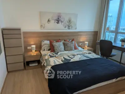 Modern bedroom with stylish decor and city view, featuring a cozy bed and workspace.