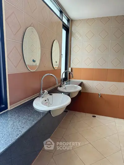 Modern bathroom with dual sinks and stylish mirrors