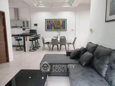 Spacious modern living room with open kitchen and stylish dining area