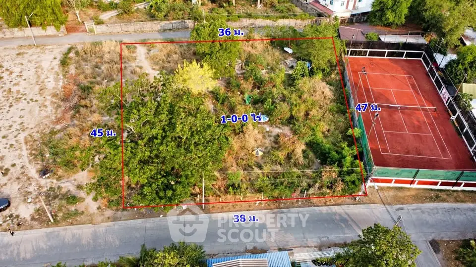 Prime real estate plot with lush greenery and adjacent tennis court, ideal for development.