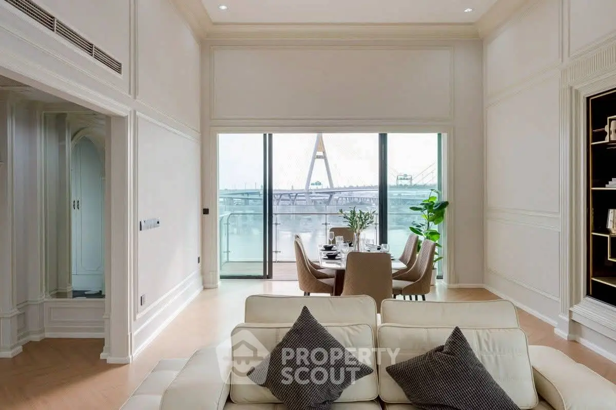 Luxurious living room with stunning river view and elegant dining area, perfect for sophisticated urban living.