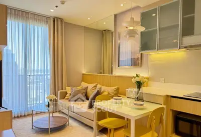 Chic modern living room with cozy sofa, dining area, and large window for natural light.