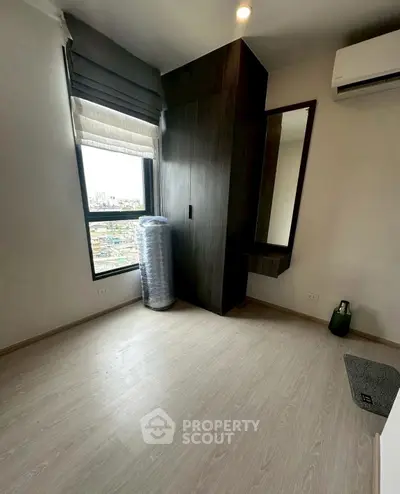Modern bedroom with sleek wardrobe and large window view