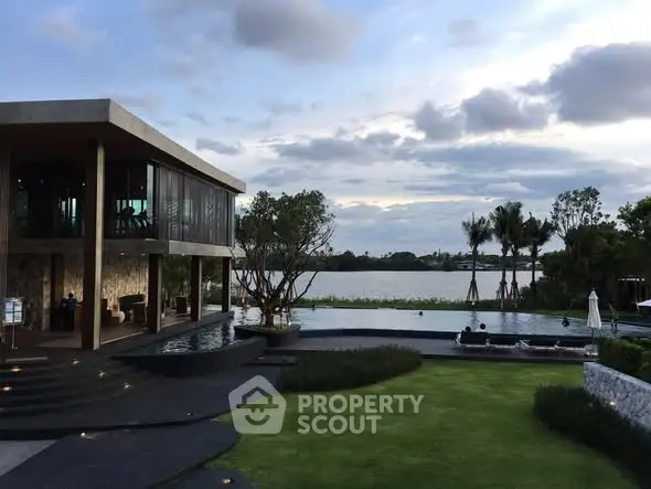 Luxurious waterfront property with modern architecture and stunning poolside view.