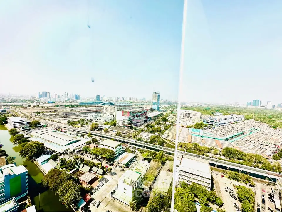 Stunning panoramic cityscape view from a high-rise building, showcasing urban development and greenery.