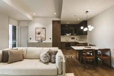 Modern open-plan living room and kitchen with elegant decor and cozy seating area.