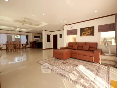 Spacious living room with elegant decor and open layout, featuring a cozy seating area and dining space.