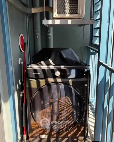Compact balcony with modern washing machine and air conditioning unit