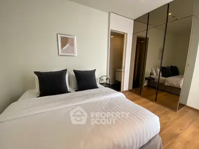 Modern bedroom with mirrored closet and stylish decor