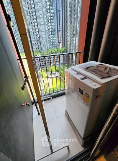 Compact balcony with washing machine and city view in modern high-rise apartment