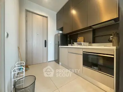 Modern kitchen with sleek cabinetry and built-in appliances in a stylish apartment.