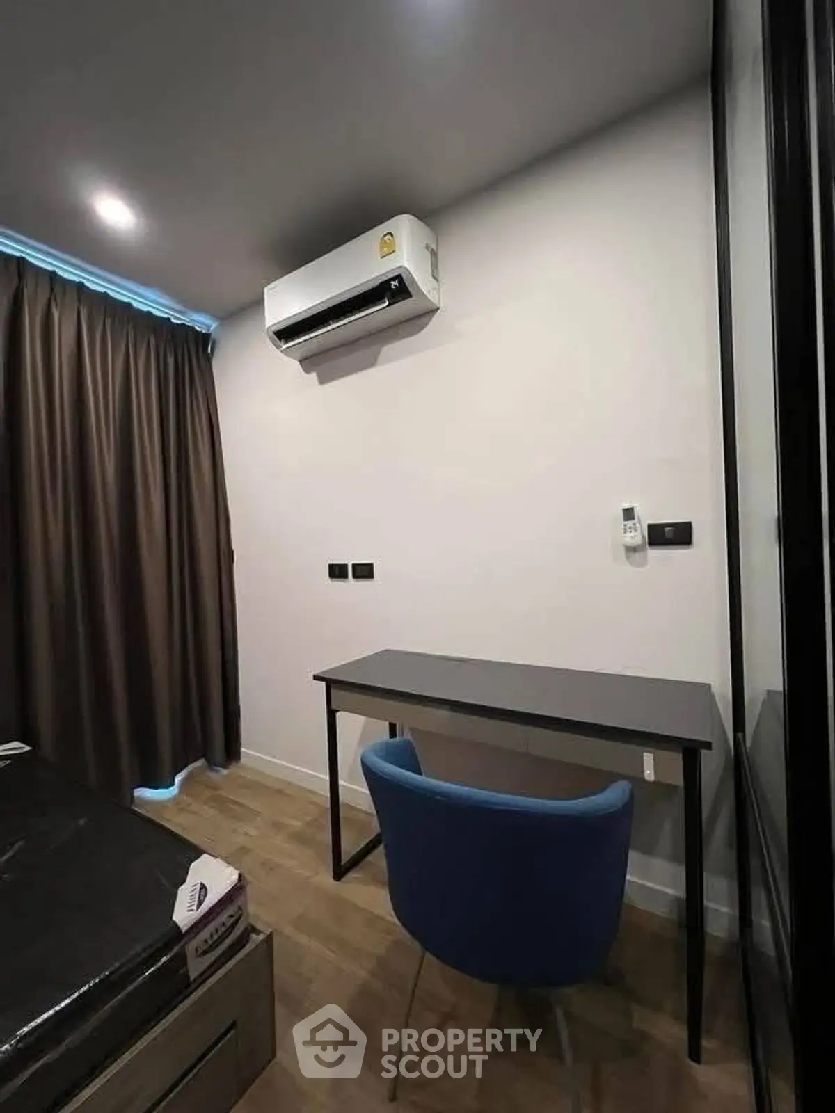 Modern study room with sleek desk and chair, featuring air conditioning and stylish decor.