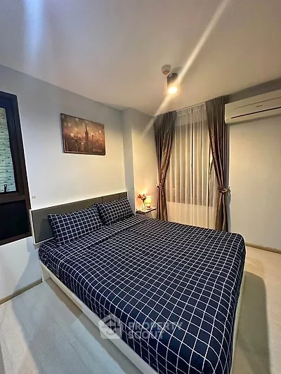 Cozy bedroom with modern decor and air conditioning in a stylish apartment.
