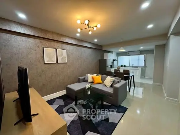 Modern living room with stylish decor and open kitchen layout, perfect for contemporary living.