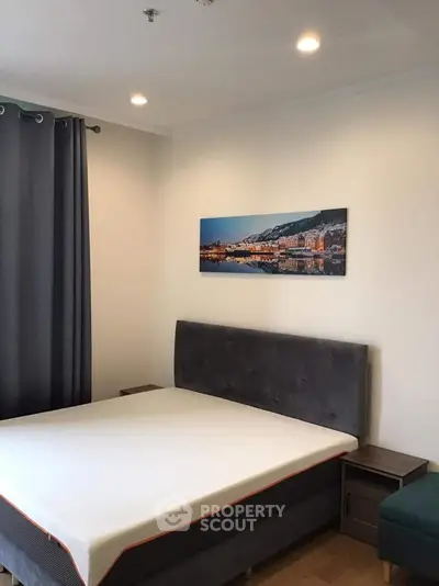 Modern bedroom with stylish decor and comfortable bed in a cozy apartment.