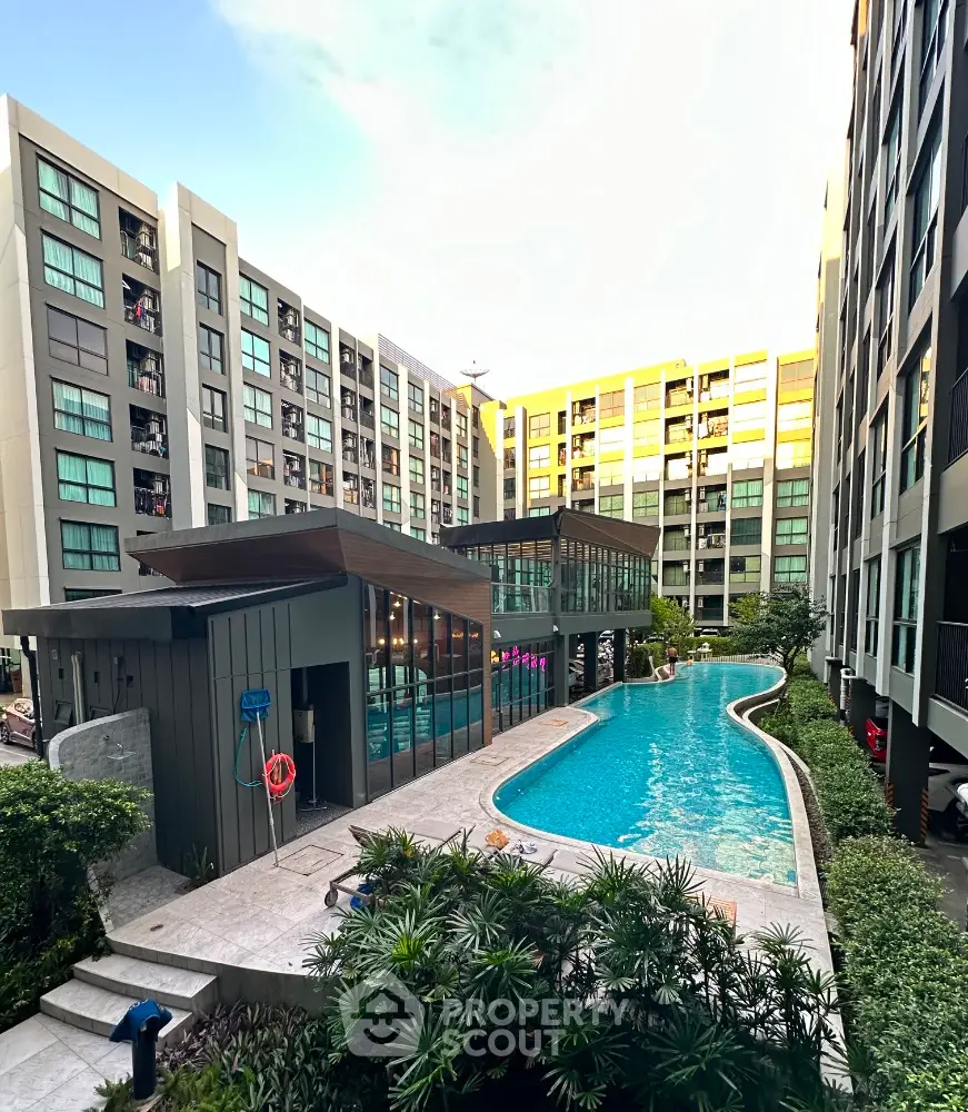 Modern condominium with luxurious pool and lush greenery