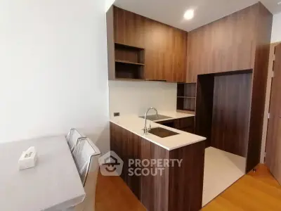 Modern kitchen with sleek wooden cabinetry and compact design