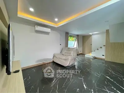 Modern living room with sleek marble flooring and ambient lighting