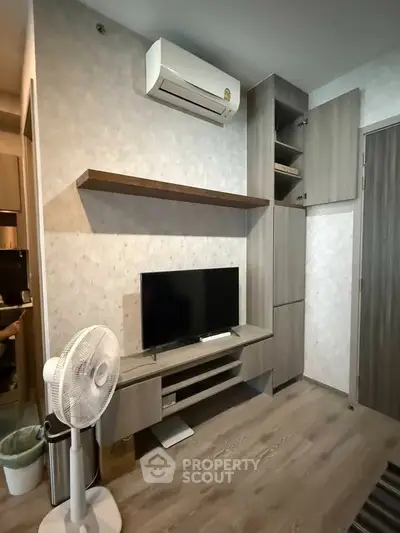 Modern living room with air conditioning and sleek wooden furniture, perfect for cozy urban living.