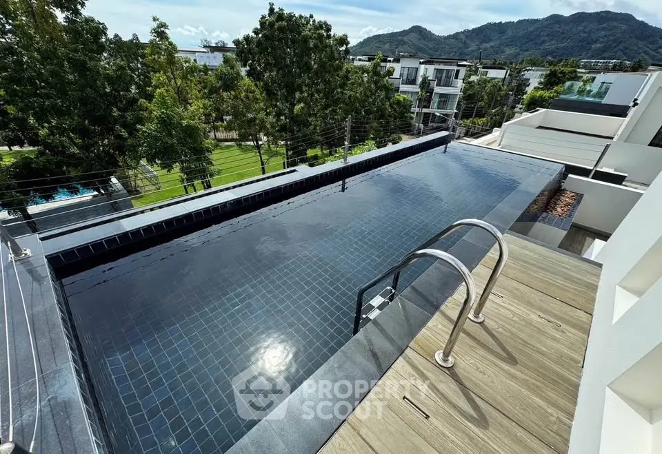 Luxurious rooftop infinity pool with stunning mountain view in modern residential area.
