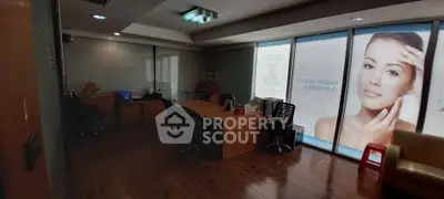 Spacious office space with modern furnishings and large windows for natural light.