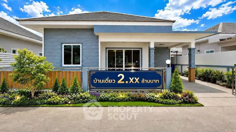 Modern single-story house with landscaped garden and stylish facade under a clear blue sky.