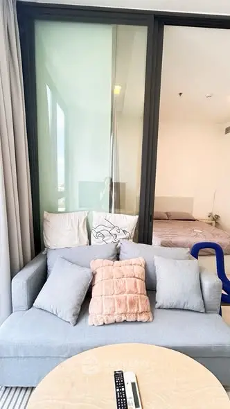 Modern living room with cozy sofa and stylish decor in a contemporary apartment.