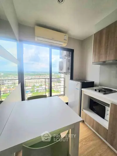 Modern kitchen with stunning city view, featuring sleek appliances and ample natural light.