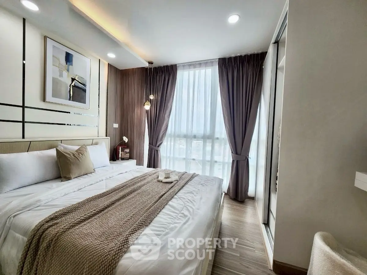 Luxurious bedroom with modern decor and large window for natural light
