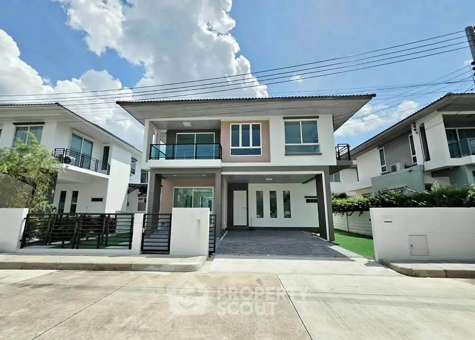 Modern two-story house with sleek design and spacious driveway in a serene neighborhood.
